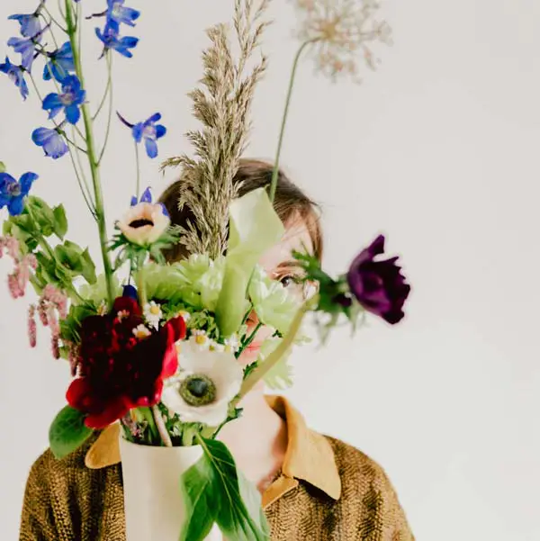 Woman holding a vase with flowers