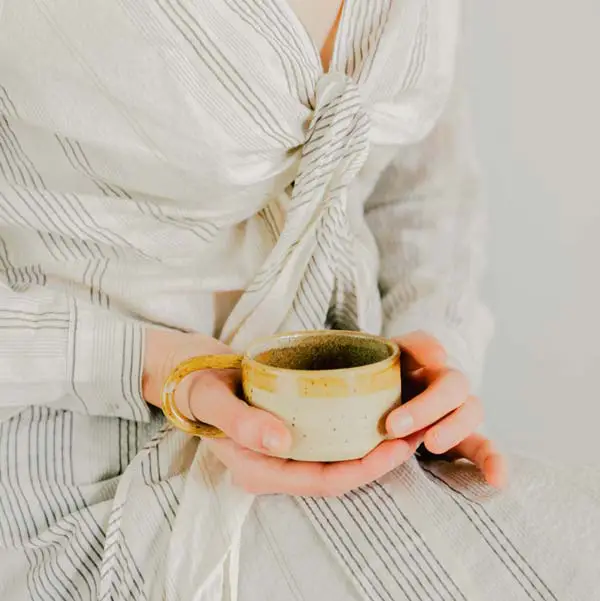 Woman holding a ceramic mug
